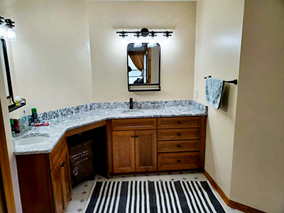 A completed bathroom remodeling project that includes two sinks and two mirrors. Houston Remodel Service can help you install a bathroom with a sink, cabinets, and more.