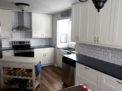 A kitchen renovation project that was completed by Houston Remodel Service. It includes white cabinets and drawers.